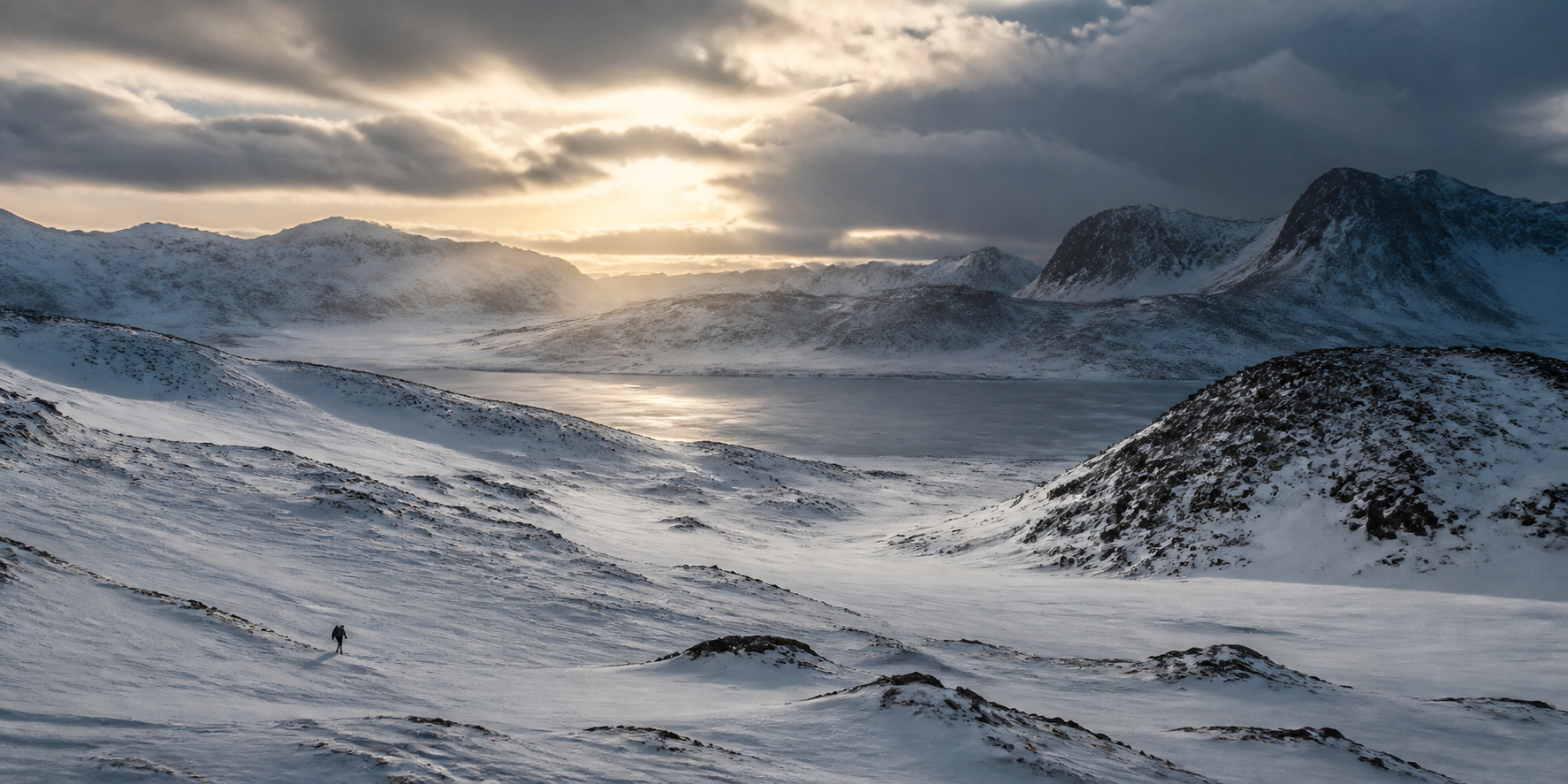 Vast snow-covered mountains and a frozen winter valley