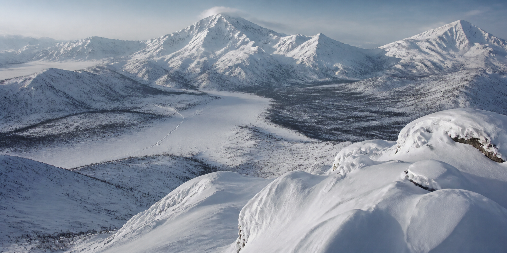 Snow-covered mountains and remote winter valleys